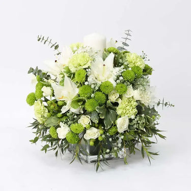 Peaceful Greens, Table Arrangement Serenity, White Oriental Lilies, Baby Roses, Green Carnations, Green Button Chrysanthemums, Green Hypericum, Pittosporum, Parvifolia, Eucalyptus, Green Sprayed Gypso, White Candle, Square Glass Vase, Centertable Arrangement